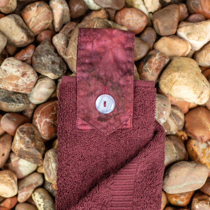 Burgundy coloured hanging hand towel. Made using the whole premium hand towel and quality cotton tab sewn to make a loop and secured with a beautiful modern button.