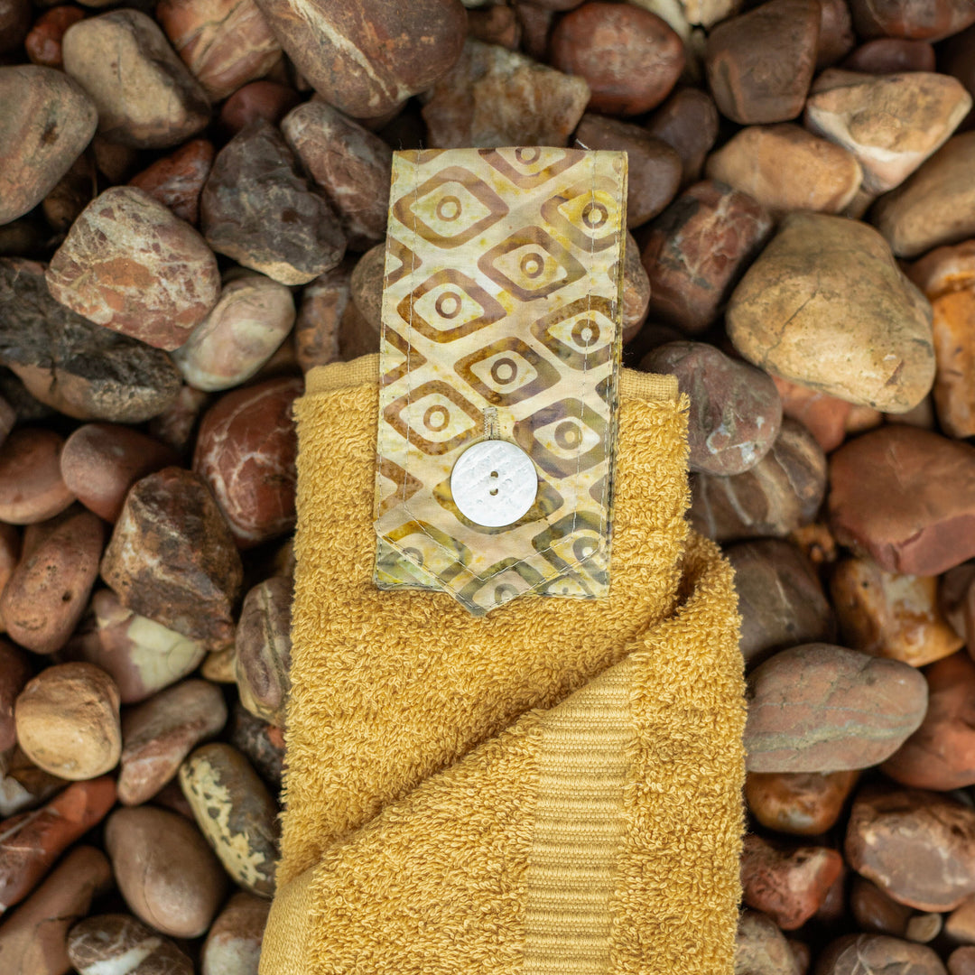 New wheat coloured hanging hand towel. Made using the whole premium hand towel and matching coloured quality cotton tab sewn to make a loop and secured with a beautiful modern button.